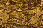 Luang Prabang, Laos - Wat Mai the gilded stucco engravings of the veranda. They narrate the Vessantara Jataka with various animals engraved at the base of the relief.